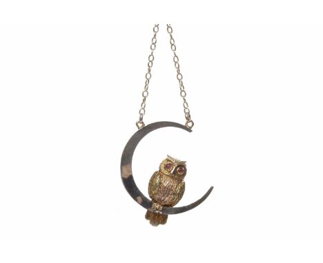 GOLD AND PLATINUM OWL MOTIF PENDANTthe owl 13.5mm high, in fifteen carat gold and perched on a platinum crescent moon motif, 
