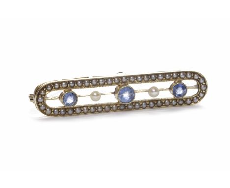 EDWARDIAN BLUE GEM AND PEARL BROOCHset with three round blue gems interspaced by two pearls, within a split pearl border, in 