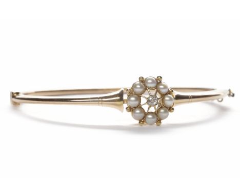 LATE VICTORIAN PEARL AND DIAMOND BANGLEwith an openwork circular pearl and diamond set section 13mmm across, the bangle 64mm 