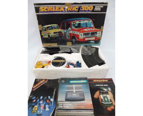 A boxed Scalextric 300 electric model racing set plus an electronic lap counter and timer.