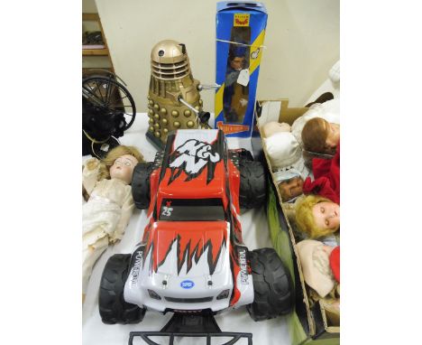 A boxed Pelham Puppet Thunderbird figure, a Chinese plastic dalek and a remote controlled car. 