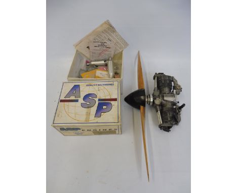 An ASP model aeroplane engine with a two blade wooden propeller and box with various contents. 