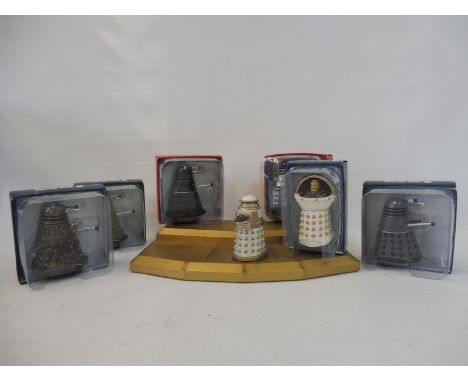 A group of six Doctor Who Darleks (five boxed), plus a stand for the set.