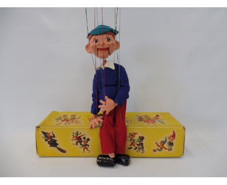 A boxed Pelham puppet 'Boy', late 1960s in generally good condition, original strings and controller. 