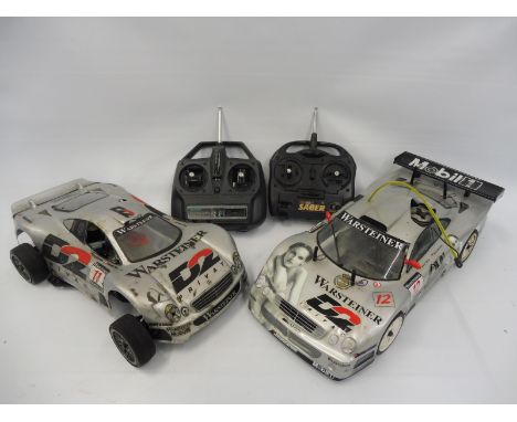 A Kyosho Mercedes&nbsp;Nitro 2WD race car and controller and a&nbsp;Kyosho Merecedes Nitro 45WD CEN engine belt driven off-ro