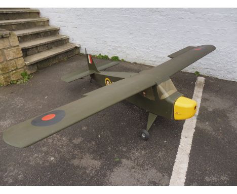 A large scale model aeroplane, lacking engine. 