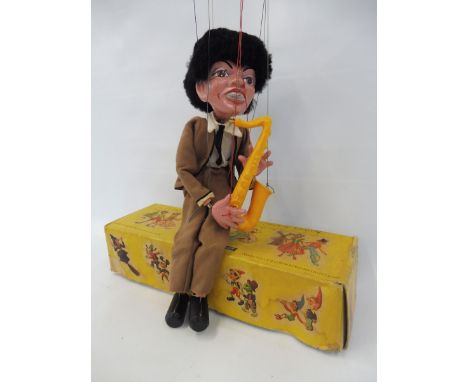 A boxed Pelham puppet 'Saxophone Player', late 1960s in non-original box in very good condition, brown outfit which supercede