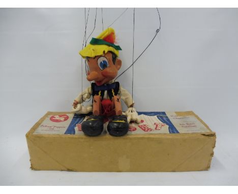 A boxed Pelham puppet 'Pinnochio', mid 1950s, in original Walt Disney box, first moulding of head that still retains tongue.