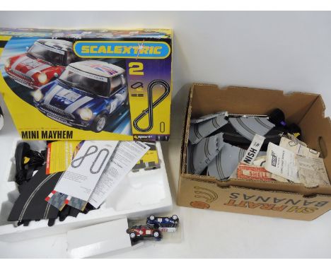 A quantity of Scalextric to include two Mini Coopers, an Advanced Track System etc.