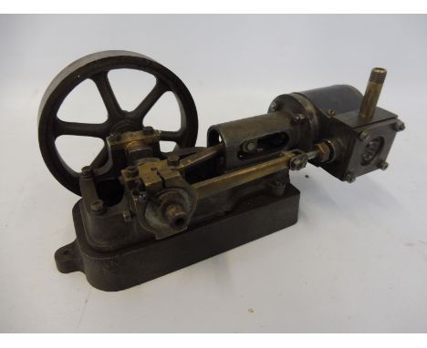 A small live steam engine with flywheel. 