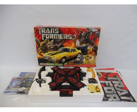 A boxed Micro Scalextric Transformers electric micro slot racing set 1:64.