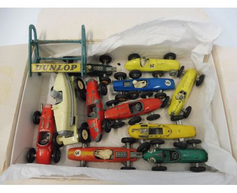 A box of early Matchbox racing cars, Dunlop stand etc.