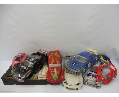 A selection of various remote controlled car instruction manuals, tools etc. and various remote controlled car bodies. 