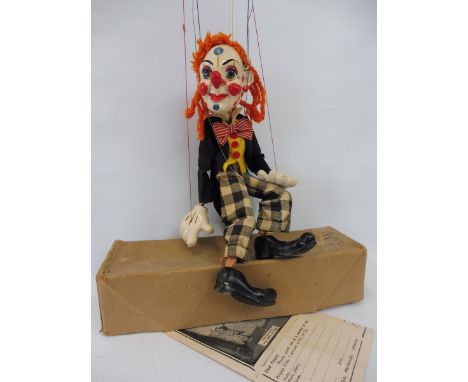 A boxed Pelham puppet 'Baby Bimbo', 1950s in very good condition, large check trousers version, original strings and controll