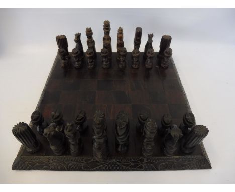 A wooden chess set on a well veneered board. 