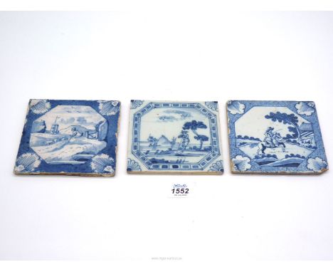 An English Delft landscape tile with powdered blue border and two other landscape tiles, all 18th century, 5" x 5" square app