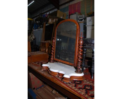 A Mahogany framed Swing Mirror with barley twist supports and white marble top to the base, some foxing to the mirror.