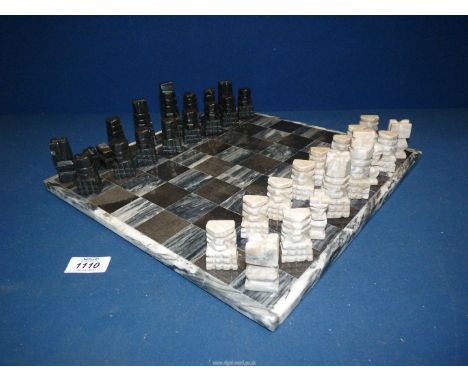 A stone Chess board and pieces (one being a/f).