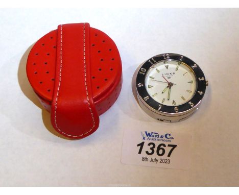 A Links of London travel alarm clock in red leather branded case.