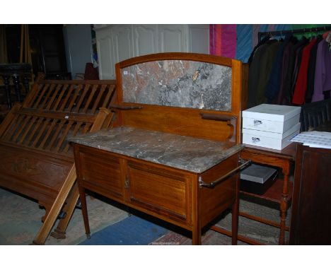 A Mahogany framed light and darkwood chequered strung Washstand having a pair of opposing doors, standing on tapering square 