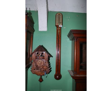 A Comitti of London mercury stick barometer in Mahogany case with silvered face, 36" long.