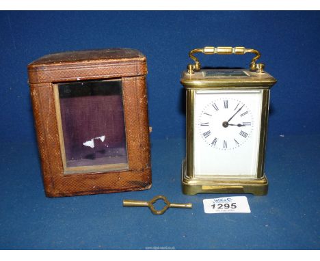 A brass Carriage Clock in leather case, with key.