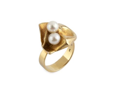 A cultured pearl dress ring designed by Björn Weckström for Lapponia, the abstract folded panel highlighted with a pair of cu