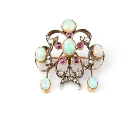A late 19th/early 20th century opal, diamond and gem set brooch/pendant, the openwork cartouche highlighted with oval cabocho