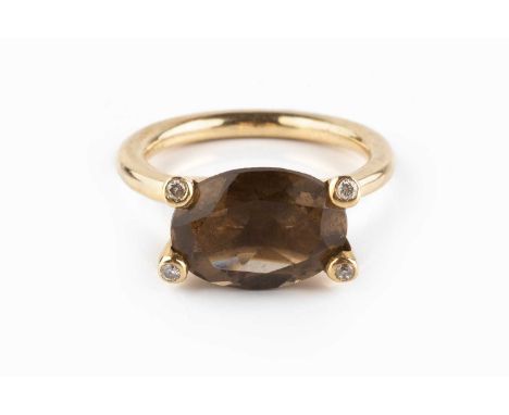 A smoky quartz and diamond dress ring, the oval mixed-cut smoky quartz in four claw setting, tipped with round brilliant-cut 