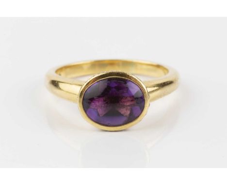 An amethyst and diamond dress ring, the oval buff-top amethyst in closed-back collet setting, edged with round brilliant-cut 