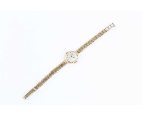 A lady's 9ct gold bracelet watch, the circular textured silvered dial with baton markers, signed Rotary, to a jewelled manual