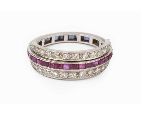 A diamond, ruby and sapphire swivel hoop eternity ring, centrally channel set with a line of rectangular step-cut sapphires t