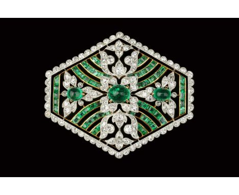 An emerald and diamond panel brooch, the openwork hexagonal panel centred with a trio of oval cabochon emeralds, framed by mi