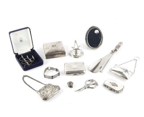 A collection of silver, comprising a square spot-hammered cigarette box, with enamel pennant to the lid, by Henry Hobson &amp