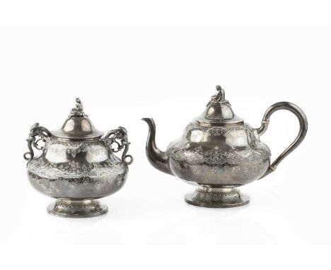 A 19th century French silver teapot and sucrier, relief decorated and engraved with stylised foliage, the lids with figural f