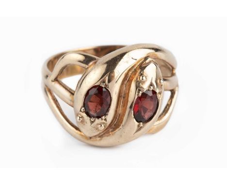 A garnet set serpent ring, designed as two entwined serpents, each highlighted with an oval mixed-cut garnet, 9ct gold mounte