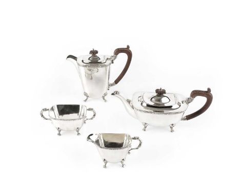 A silver four piece tea service, with Celtic design borders, dragon mask handles and scroll feet, the teapot and hot water po