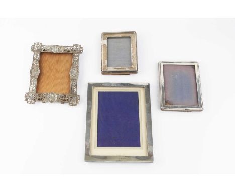A late Victorian silver rectangular photograph frame, pierce-decorated with panels of classical urns and swags, and with port
