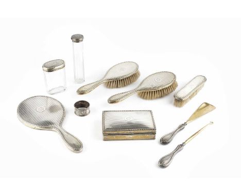 A George V silver dressing table set, with engine turned and raised husk decoration, comprising a rectangular trinket box, 14