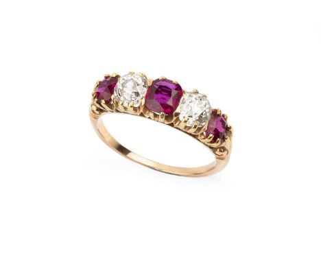 A ruby and diamond five stone ring, the alternate cushion-shaped rubies and old-cut diamonds in claw setting, between scrolle