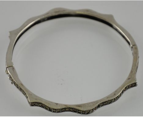 A silver bangle set with marcasite