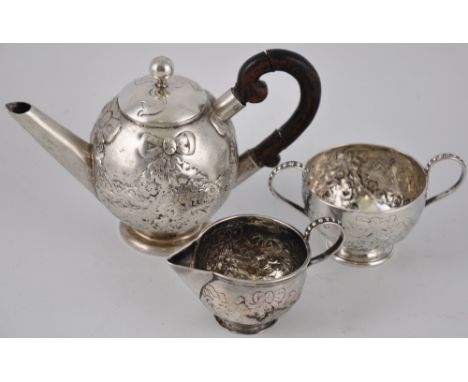 A silver three piece tea set, teapot, sugar bowl and a miniature cream jug