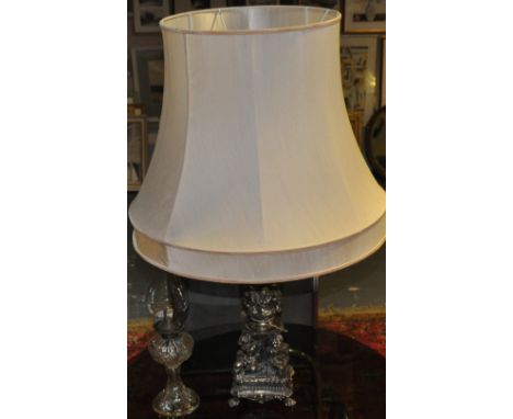 A cast alloy table lamp, the Corinthian column supported by four putti, H. 56cm, together with a moulded glass oil lamp, and 