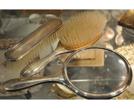 A silver three piece mirror and bush set, Birmingham, engine turned  engraved with initials, (3)
