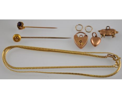 A quantity of gold, to include a 9ct gold chain, a 9ct gold padlock charm, together with two further gold charms and two stic