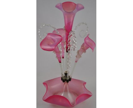 A late Victorian cranberry and opaque glass epergne the four flutes divided by twist canes on shaped circular base, H52cms