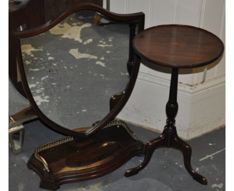 An Edwardian shield-shaped dressing table mirror with swivel and pivot mount, on three quarter galleried serpentine base, H. 