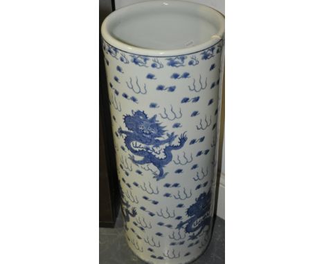 A 20th century blue and white stick stand, of cylindrical form decorated with dragons and clouds, H. 62cm.