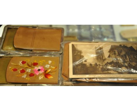 An early 20th century brown leather wallet, the interior embroidered with flowers, together with a small collection of postca