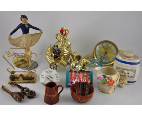 A painted cast metal alloy table lighter modelled as an ice skater, H. 24cm, a novelty horse-drawn decanter, the stopper mode